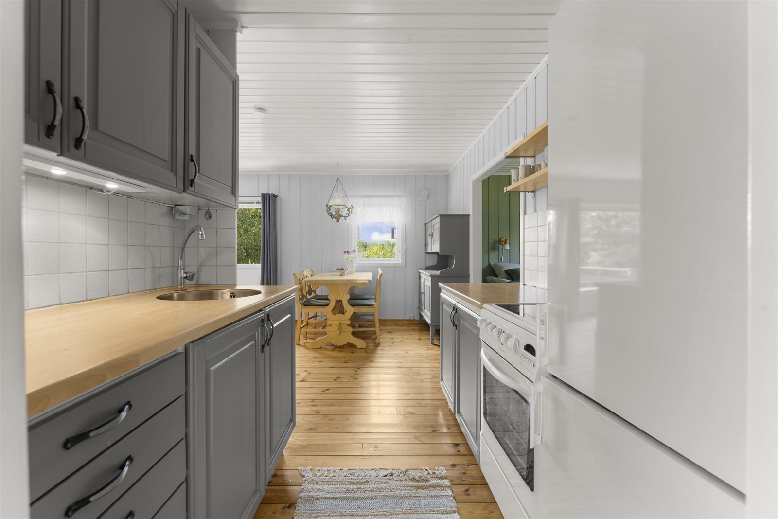 Kjøkkenet har godt med skap- og benkeplass Galleribilde