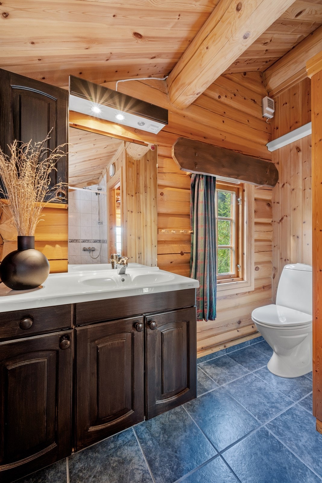 Det vinklete badet på 4 kvm utnytter arealet maksimalt, og kombinerer flott innredning med god takhøyde - for en både luftig og innbydende atmosfære. Galleribilde