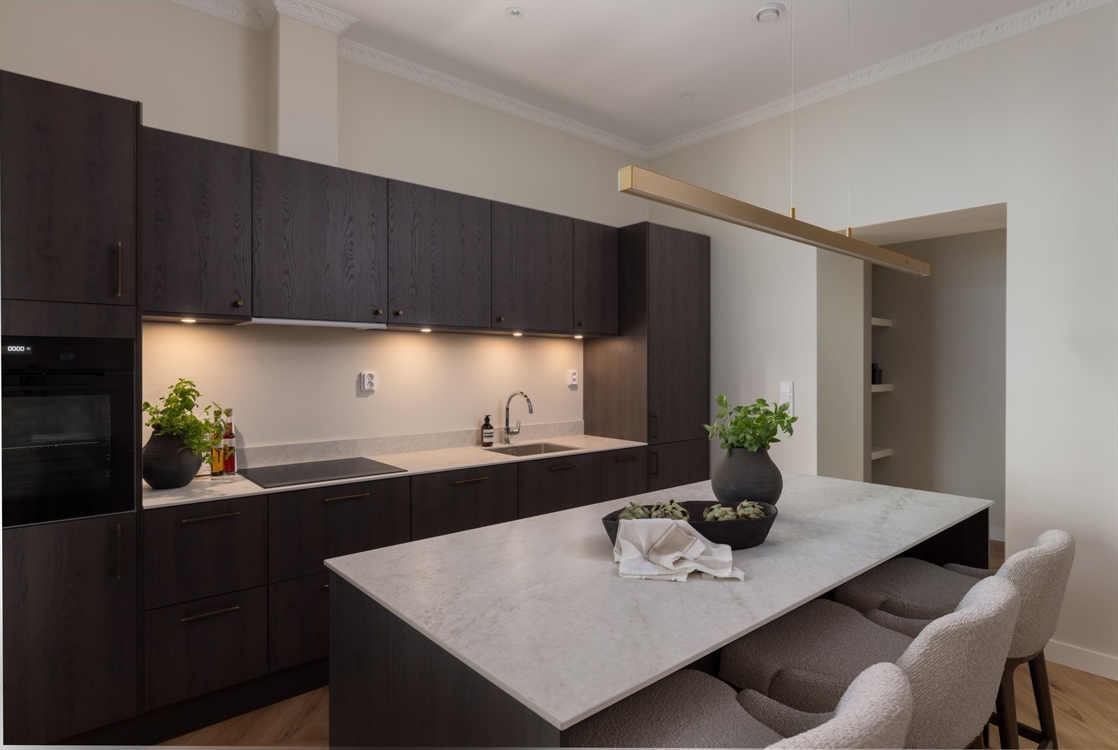 Kjøkken leveres med integrert induksjonsplatetopp med ventilator, oppvaskmaskin og kjøle/fryseskap, samt LED belysning over benk og under overskap. Galleribilde