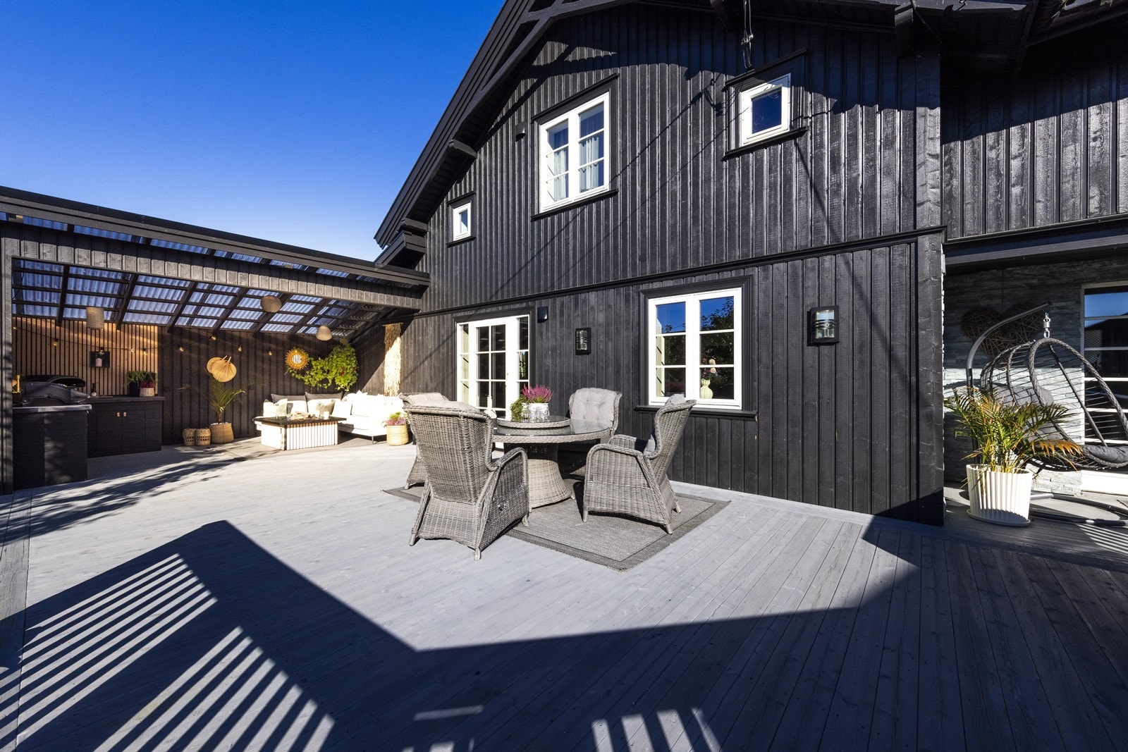 Boligen byr på en stor terrasse og flere hyggelige soner rundt i hagen. Galleribilde