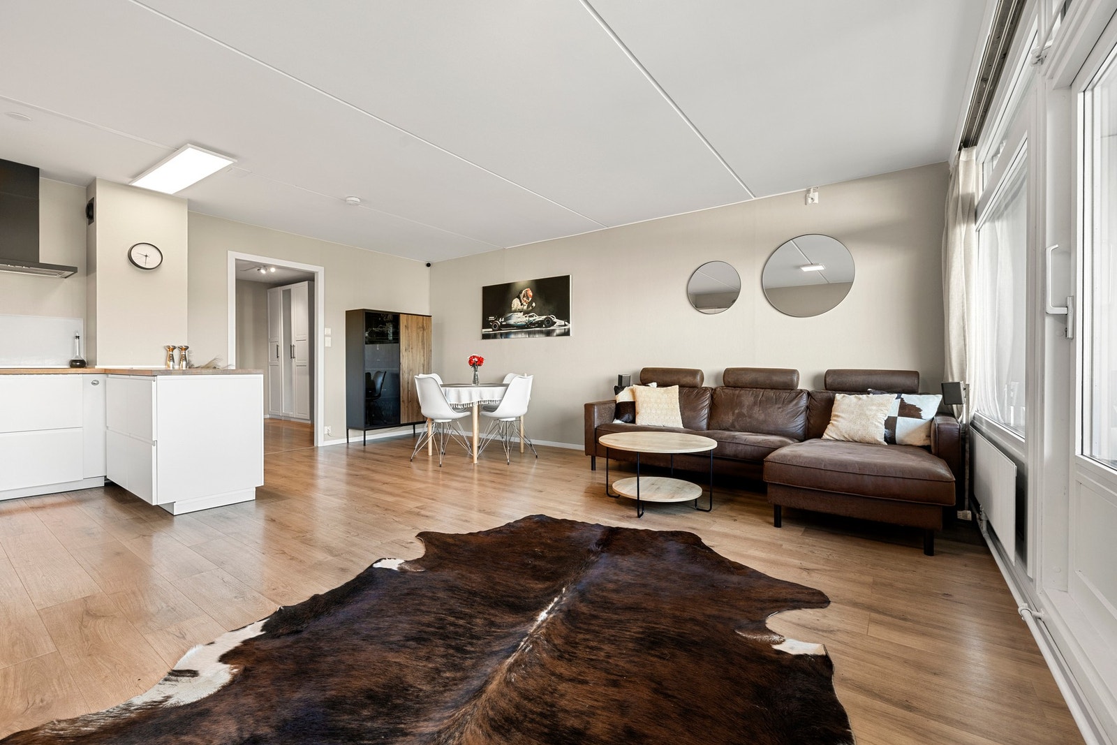 Lys og moderne stue med store vindusflater som slipper inn rikelig med dagslys. Galleribilde