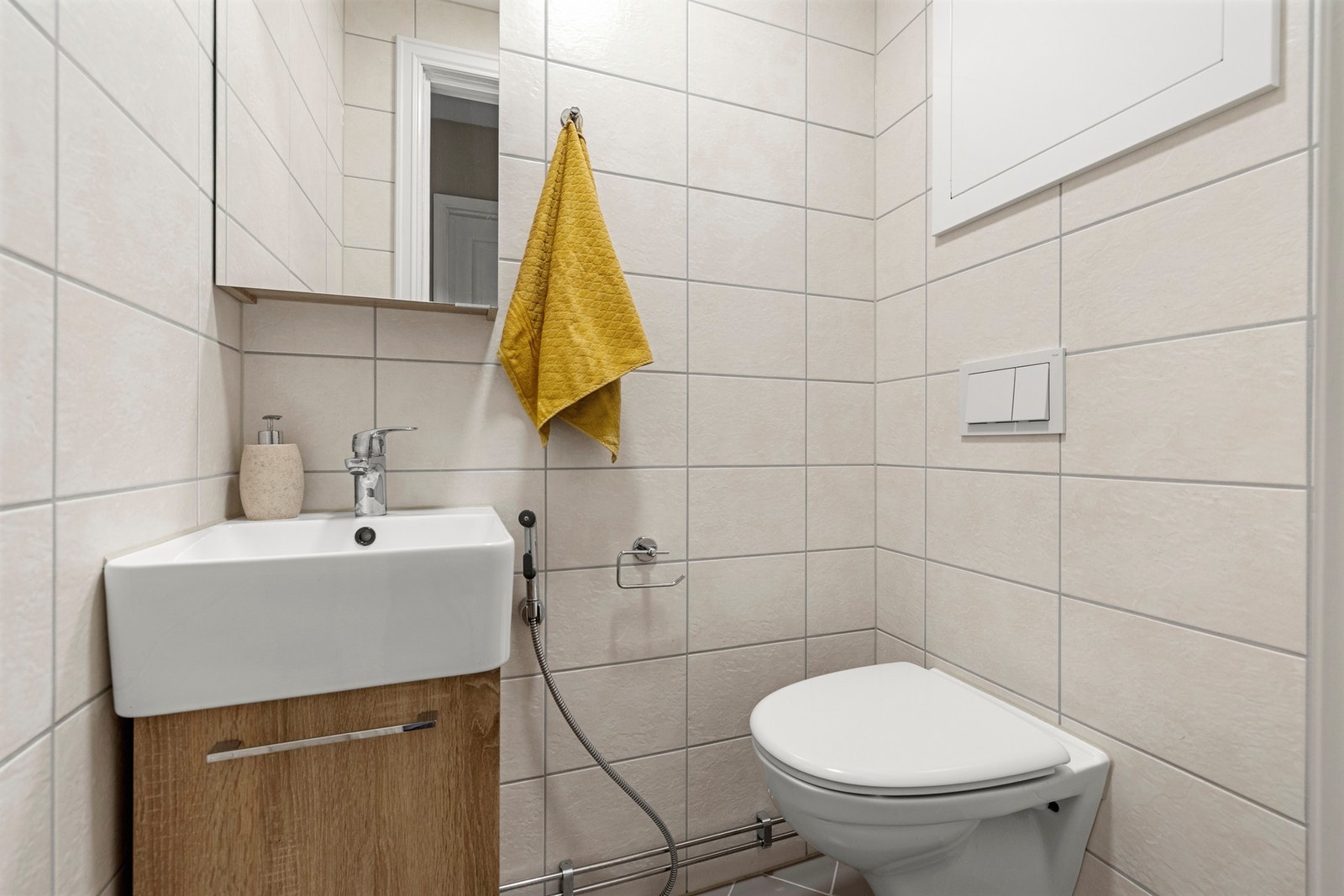 Stilrent toalett med moderne fliser og vegghengt wc. Galleribilde
