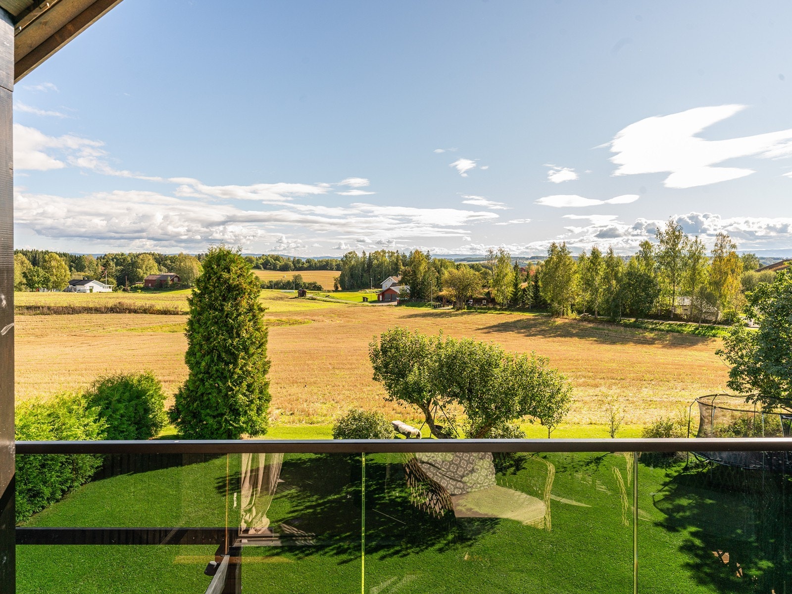 Fra boligen har man en vidstrakt utsikt over det åpne kulturlandskapet i Ridabu. Galleribilde