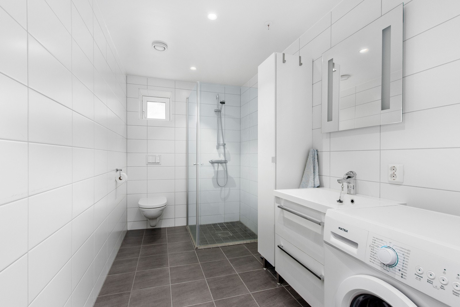 Praktisk bad med flis og innslående dusjvegger. Skuffeseksjon. Galleribilde