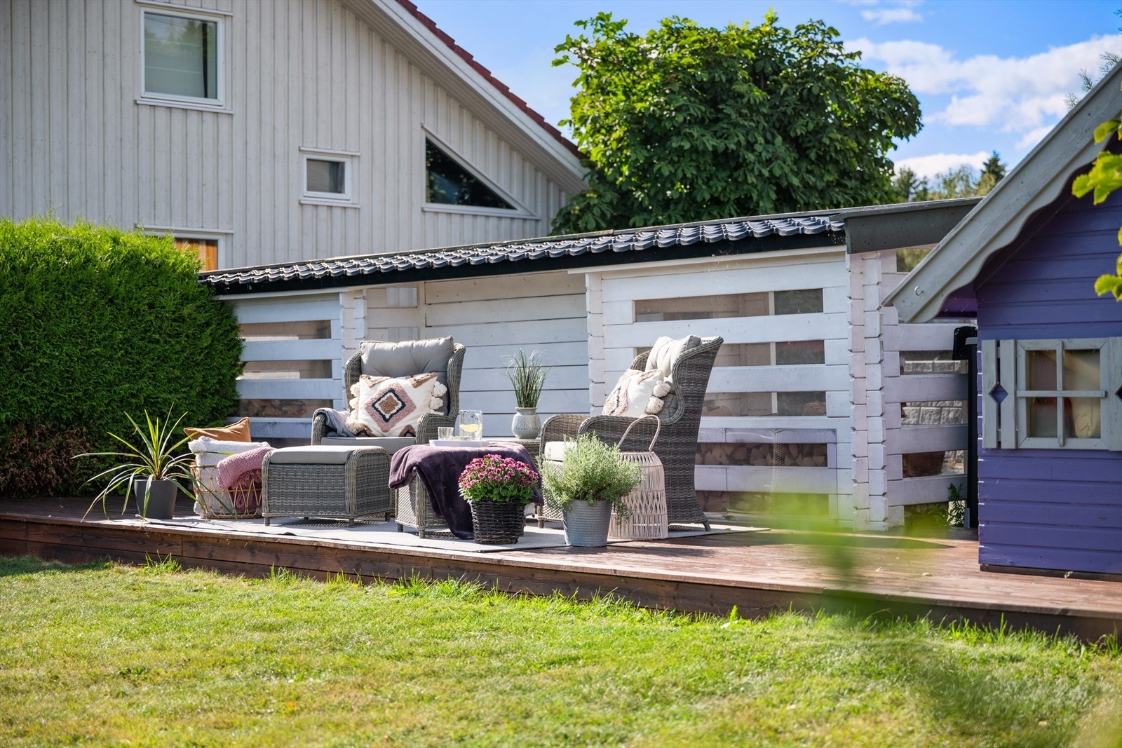 - I hagen finner du en markterrasse med to overbygde vedskjul og en sjarmerende lekestue - Galleribilde