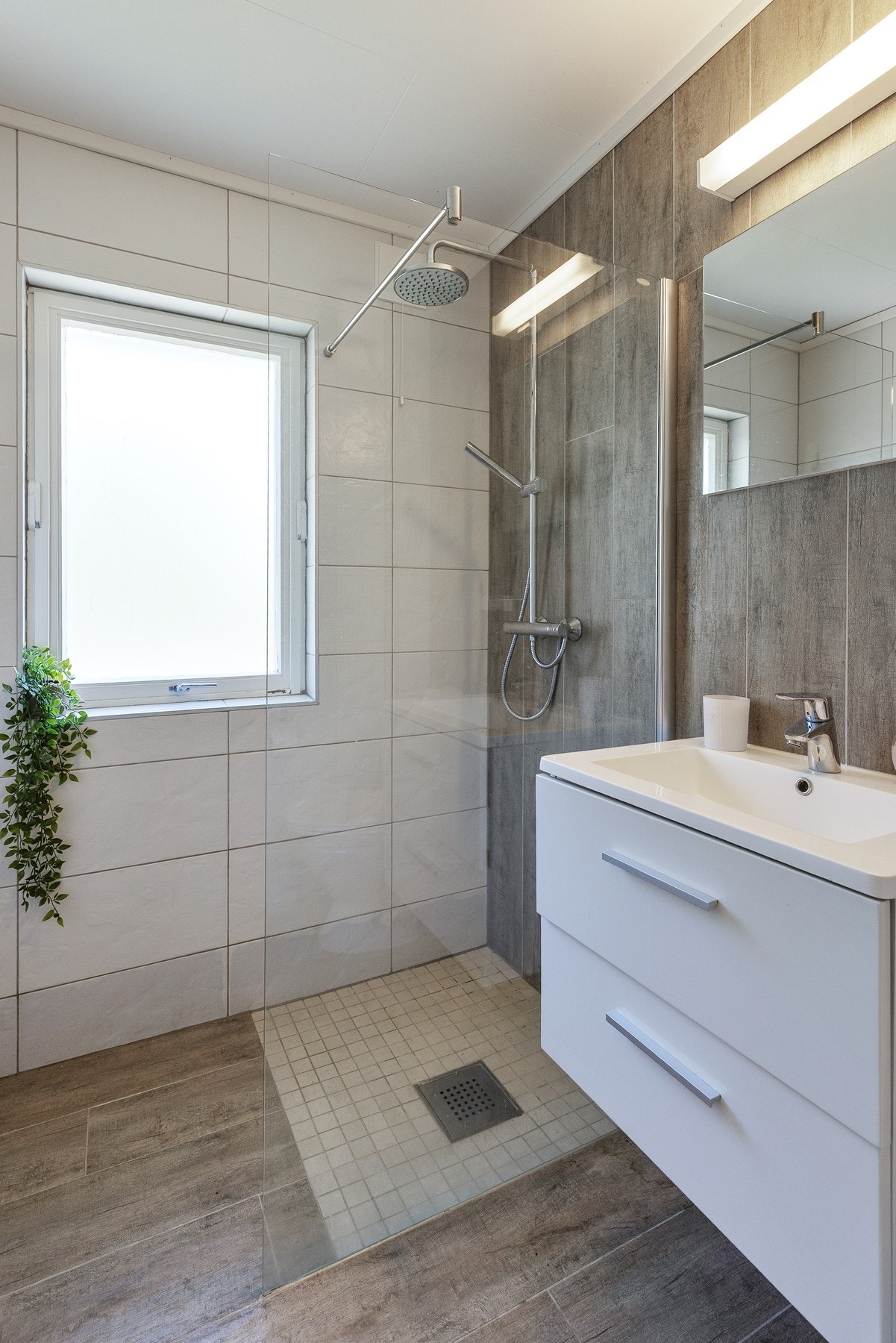 Gulvmontert toalett og dusjhjørne med fastmontert dusjvegg i glass med regndusj og hånddusj Galleribilde