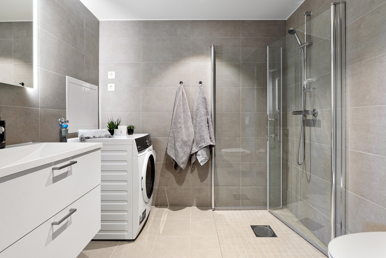 Flislagt bad med moderne innredning og varme i gulv. Galleribilde