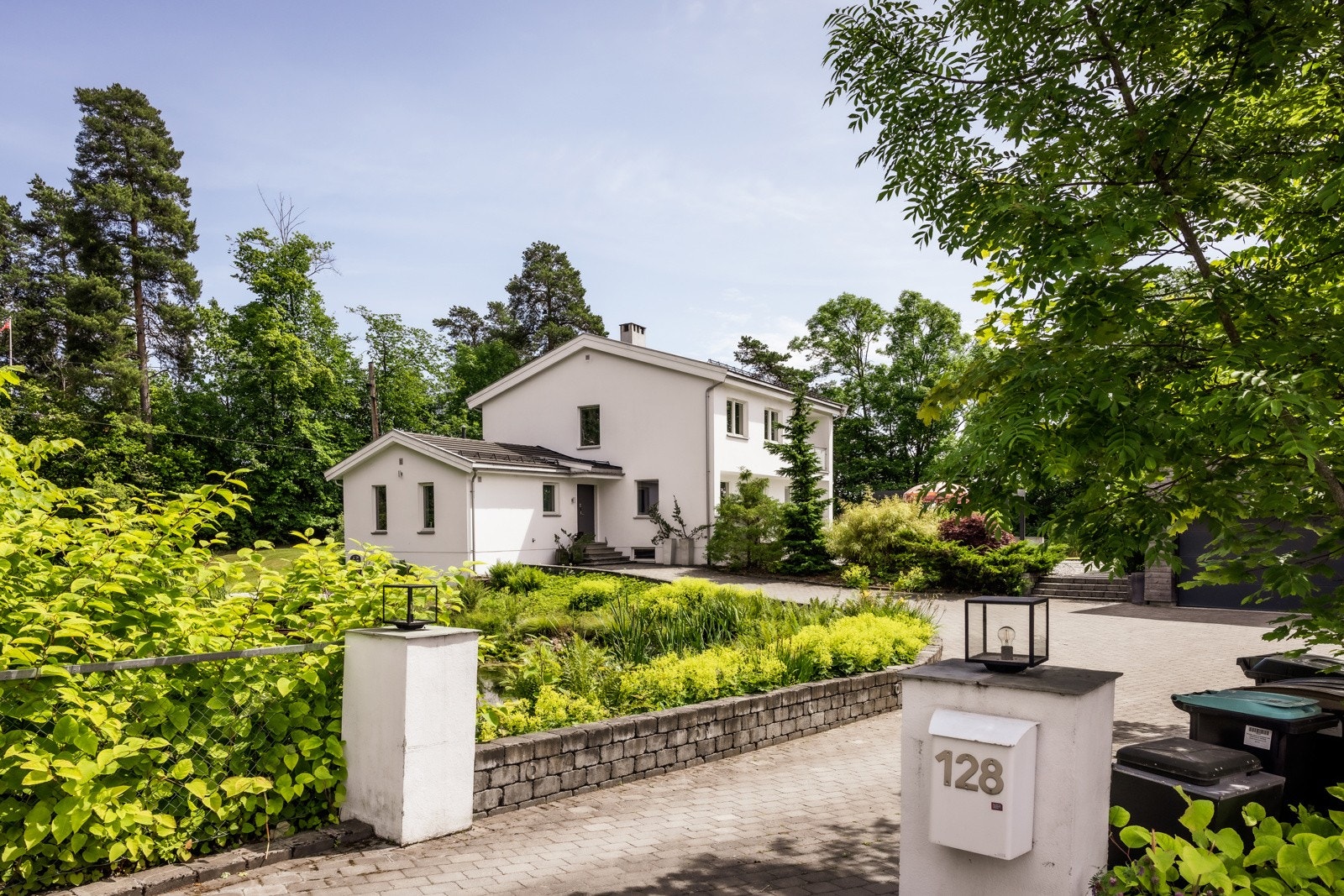 Vakker fasade med garasje til 2 biler, og stor åpen plass med plass til ytterligere parkering