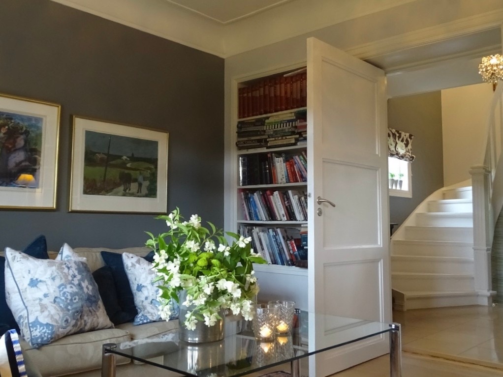 Plassbygde bokhyller på begge sider av døren Galleribilde