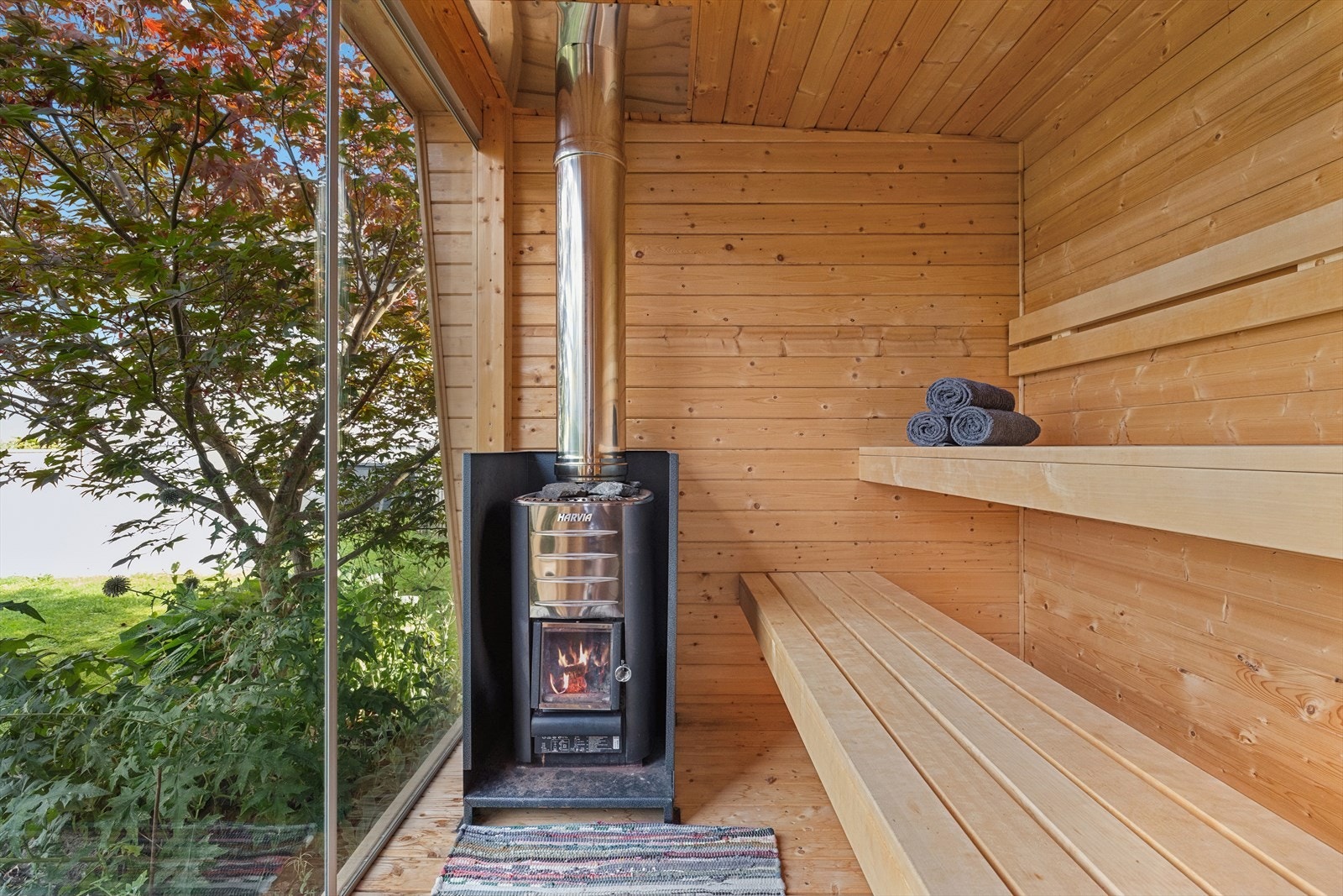 Badstuen er innredet med sittebenker og ovn, samt store vinduer. Galleribilde