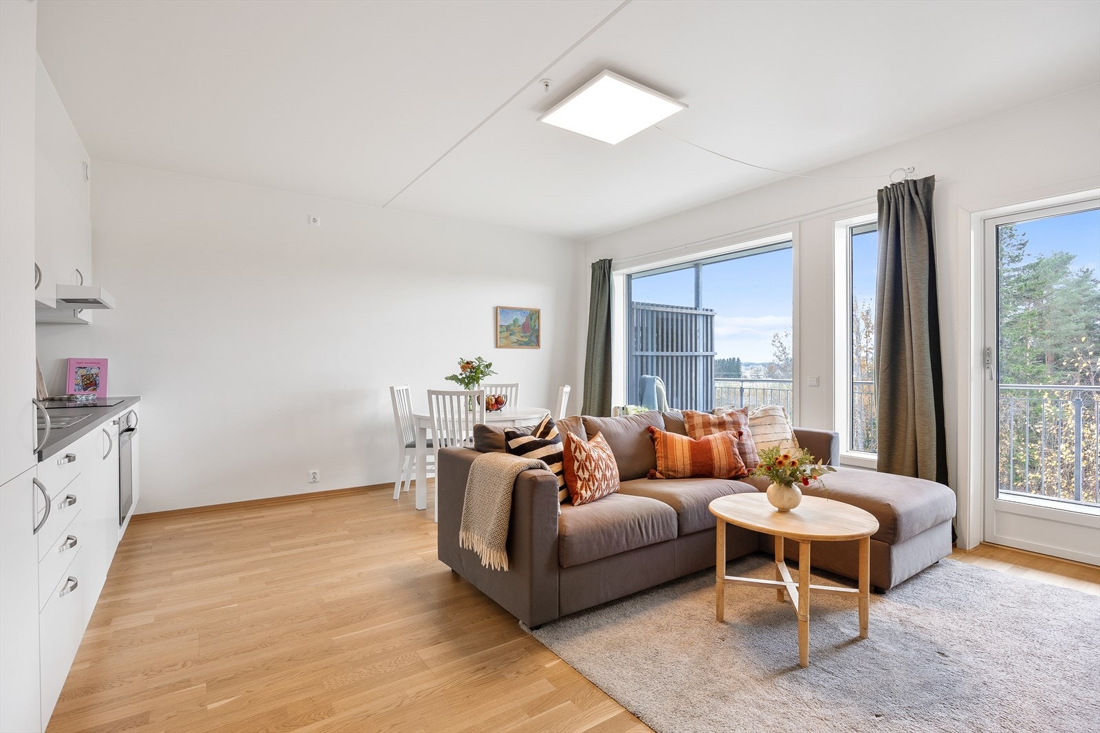 Leilighetens sosiale sone består av en åpen løsning mellom stue og kjøkken, noe som skaper en luftig og sosial atmosfære. Galleribilde