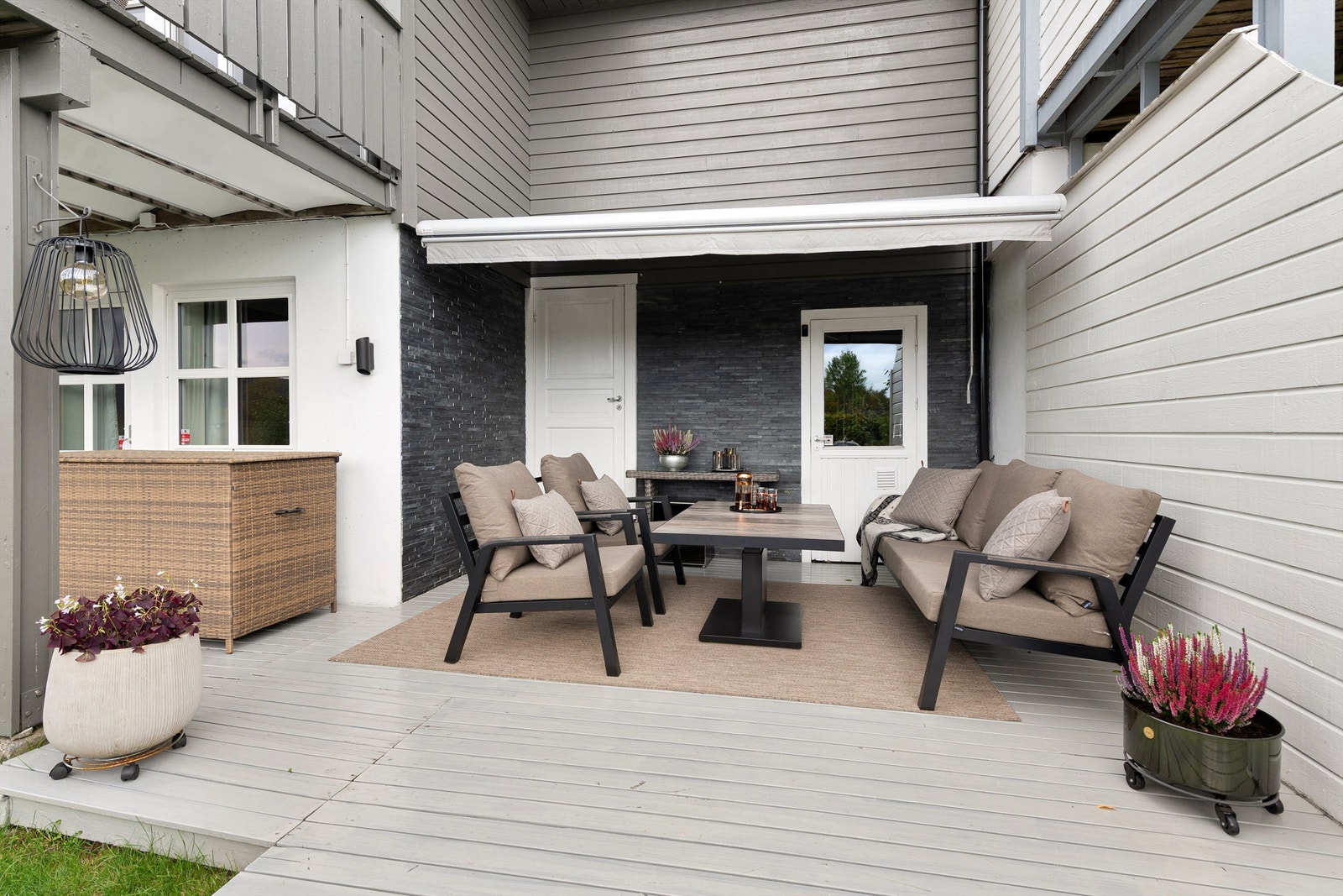 Koselig del av terrassen med levegg mot nabo og markise over Galleribilde