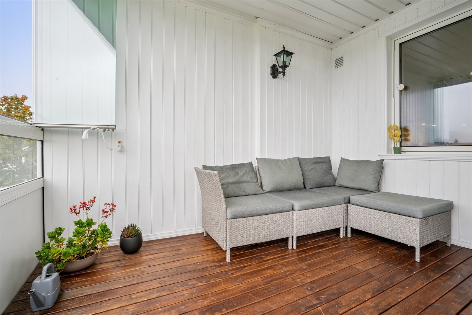 Verandaen har beiset spaltegulv, utelys, samt tett rekkverk med skyveglass vinduer Galleribilde