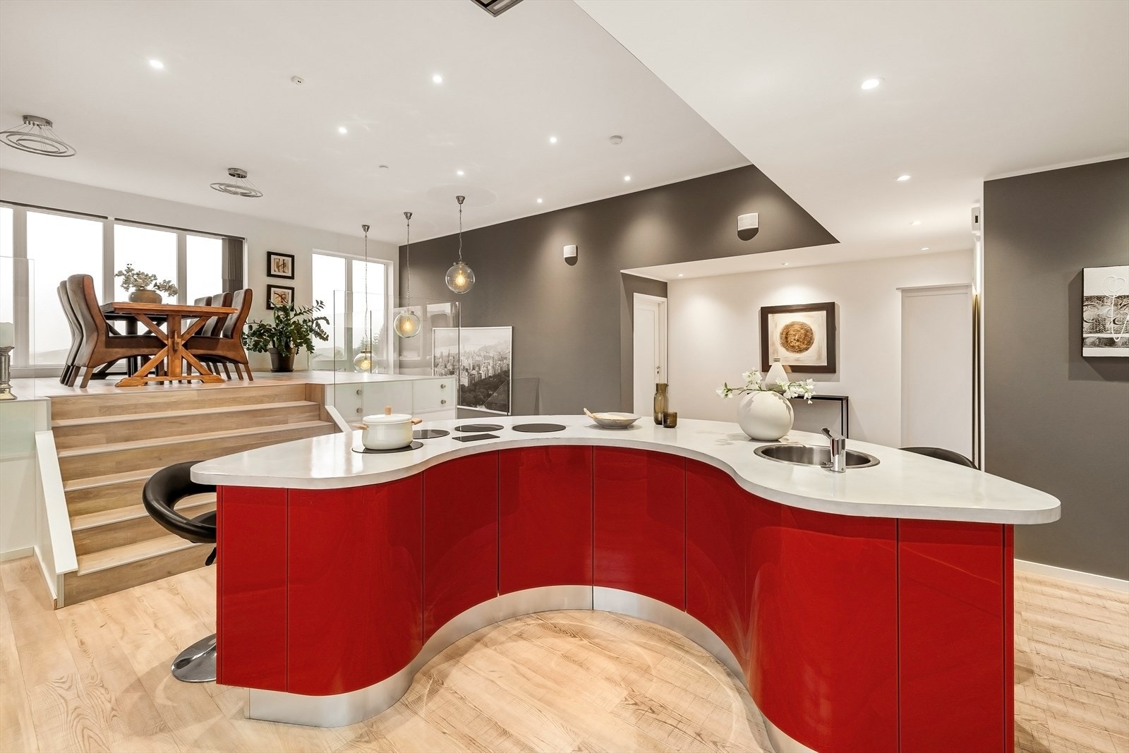 Den røde, bølgende kjøkkenøya gir et lekent og eksklusivt preg, hvor det er plass til både matlaging og gode samtaler. Galleribilde