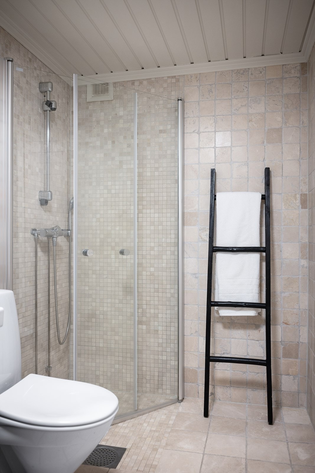 Rommet er innredet med moderne servantskap med nedfelt servant, speilskap med speildører og vegghengt belysning. Dusjhjørne med innfellbare glassdører i herdet glass, samt gulvmontert toalett. Galleribilde