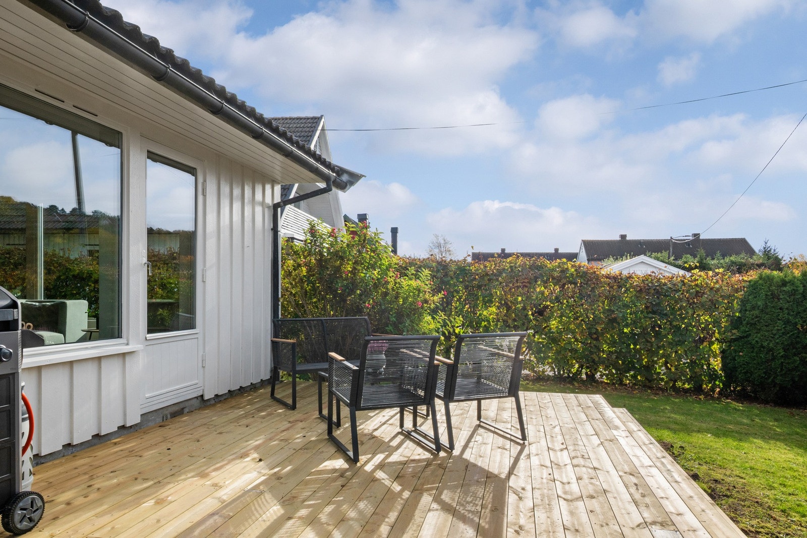 Terrassen har adkomst fra stuen og bred trapp ned til hagen. Galleribilde