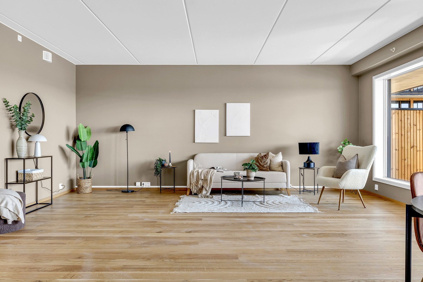 Romslig stue plass til flere sittegrupper Galleribilde