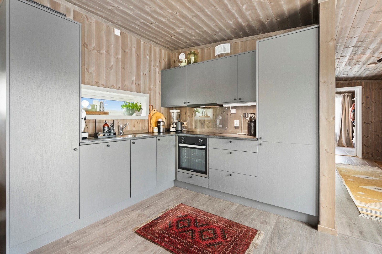 Boligen har lunt trepanel på vegger og tak. Galleribilde