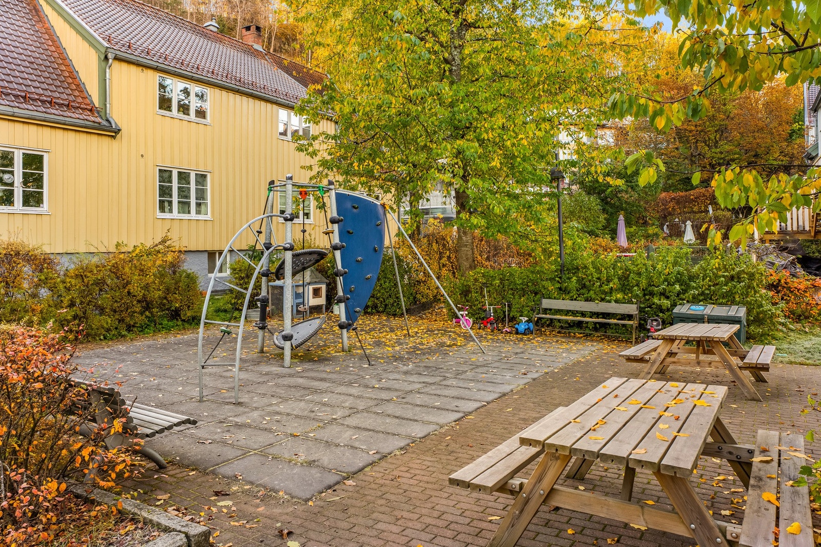 Fellestomten er pent opparbeidet med gressplen, prydbusker, trær og asfalterte internveier, og det er lekeapparater og sittebenker til felles anvendelse ved enden av bygningene. Galleribilde