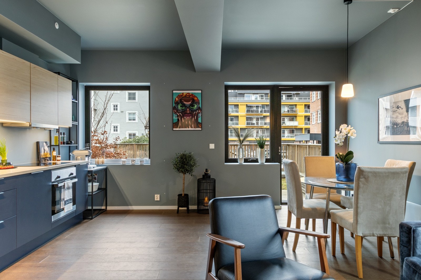 Moderne kjøkken med stilrene detaljer og åpen løsning mot spiseplass. Et lyst og sosialt rom med direkte utgang til markterrassen Galleribilde