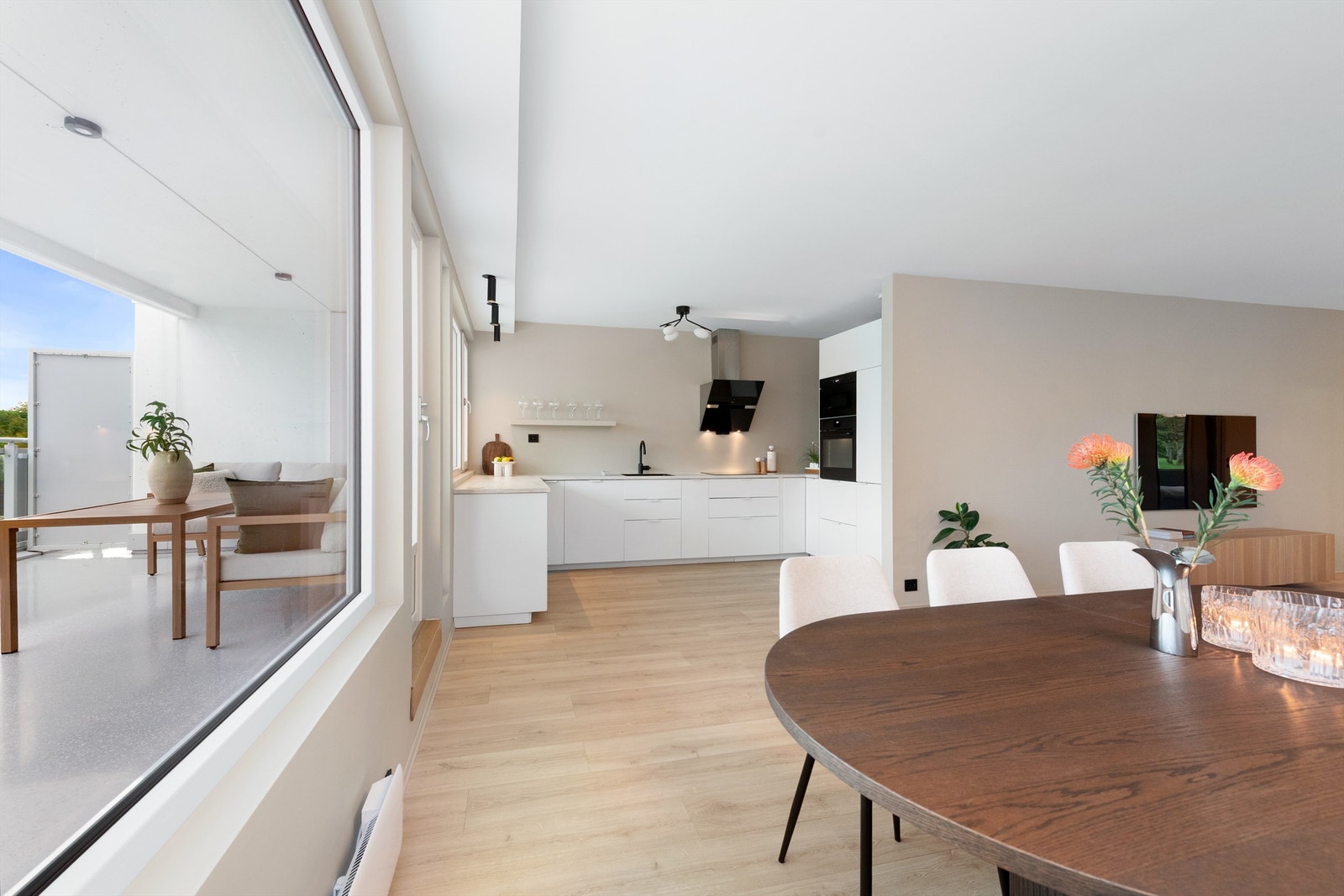 Kjøkken fra IKEA med glatte fronter og laminat benkeplate, et moderne uttrykk og gjennomført stil Galleribilde