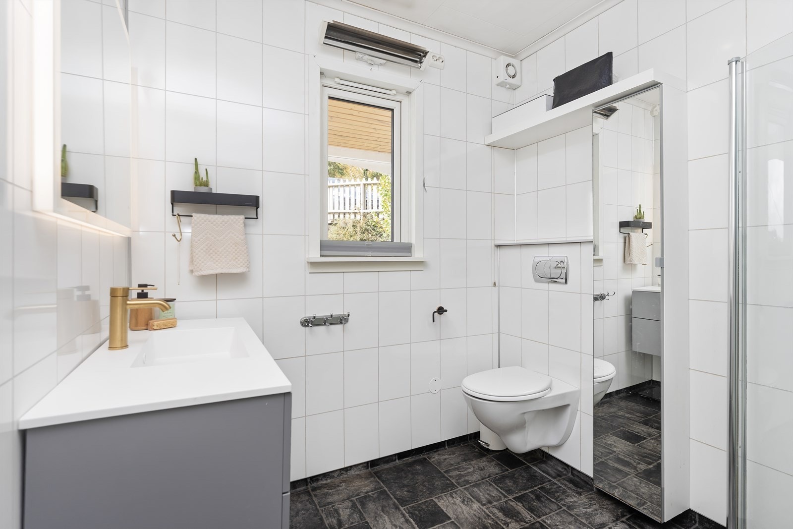 Badet er innredet med servant, wc og dusjhjørne. Galleribilde