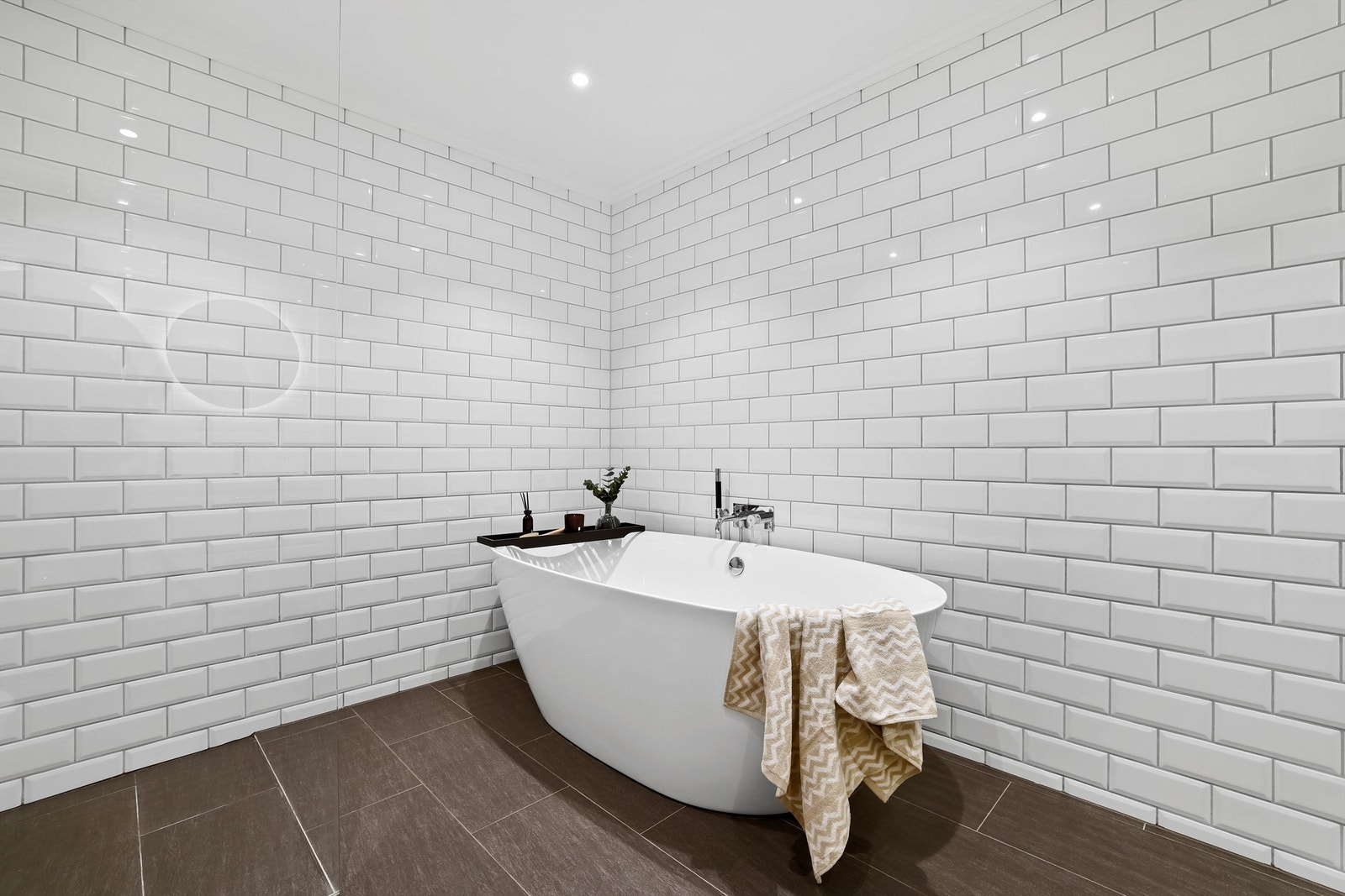 Lekre hvite metrofliser pryder alle badets veggflater. I gulvet er det varme. Himlingens spotter kan dimmes til ønsket stemning. Galleribilde