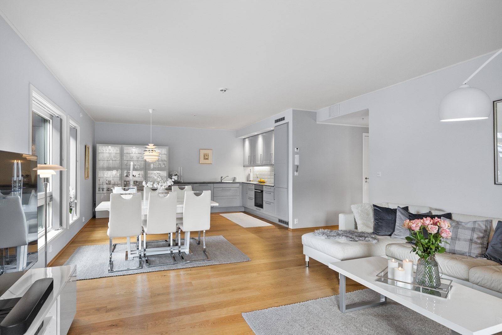 Stue og kjøkken utgjør hjertet av denne flotte leiligheten - et rom som virkelig inviterer til både hverdagshygge og sosiale sammenkomster. Galleribilde