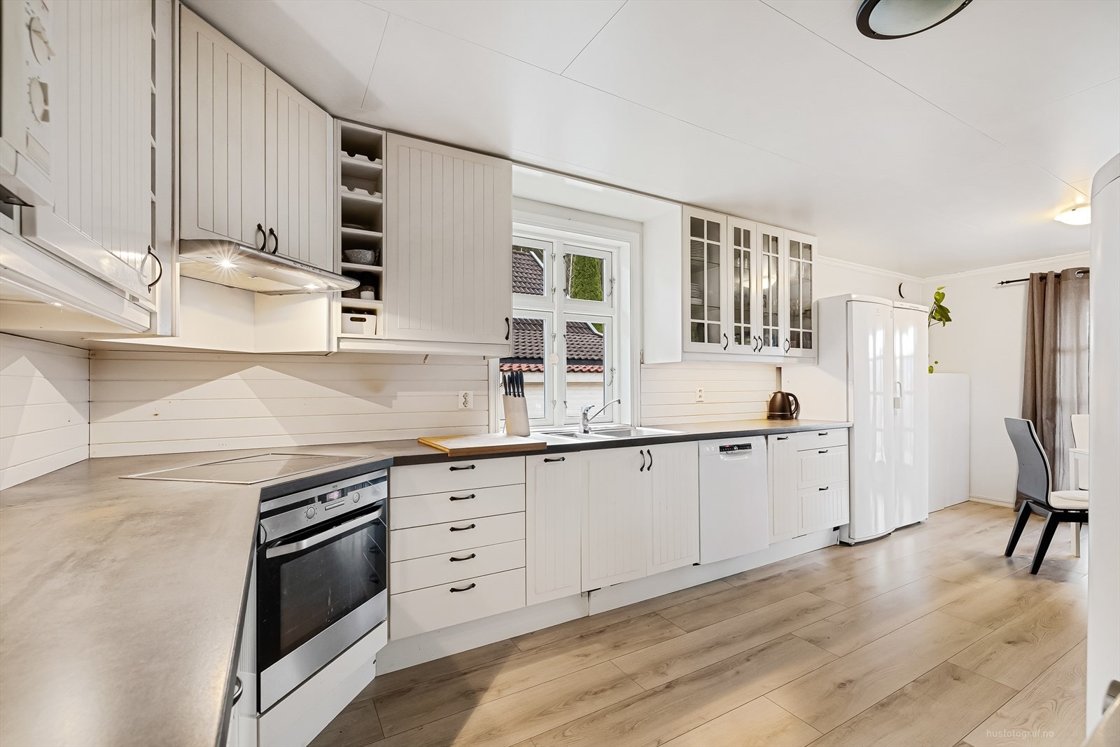 Kjøkkenet er praktisk innredet med lyse overflater, laminat benkeplate samt integrert stekeovn, platetopp, ventilator og oppvaskmaskin. Galleribilde