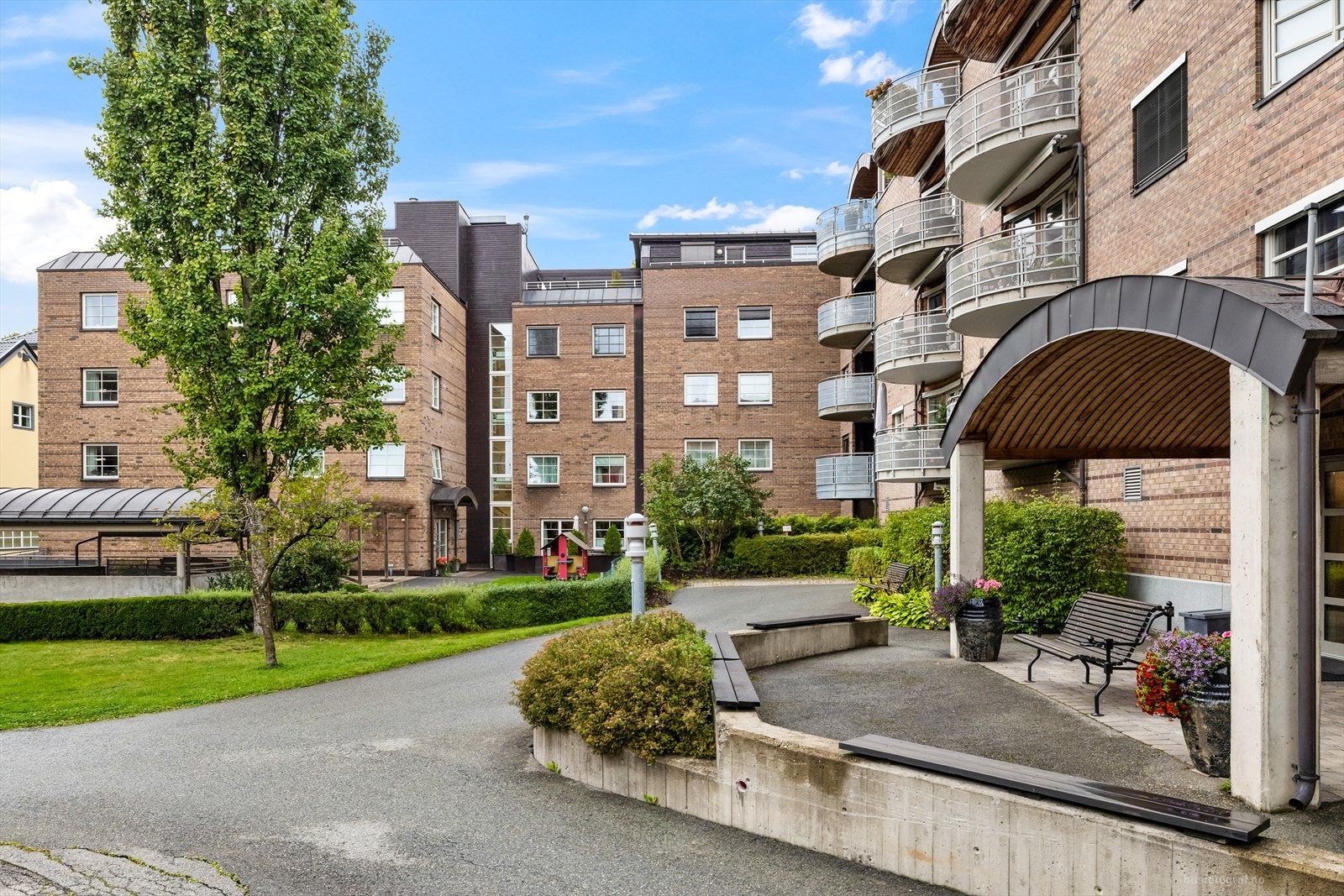 Opparbeidede fellesarealer med gressplen og beplantninger. Galleribilde