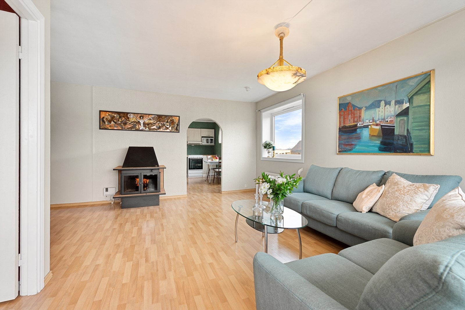 Stuen har ildsted. Med enkle grep kan man om ønskelig lage åpen løsning mellom stue/kjøkken. Galleribilde