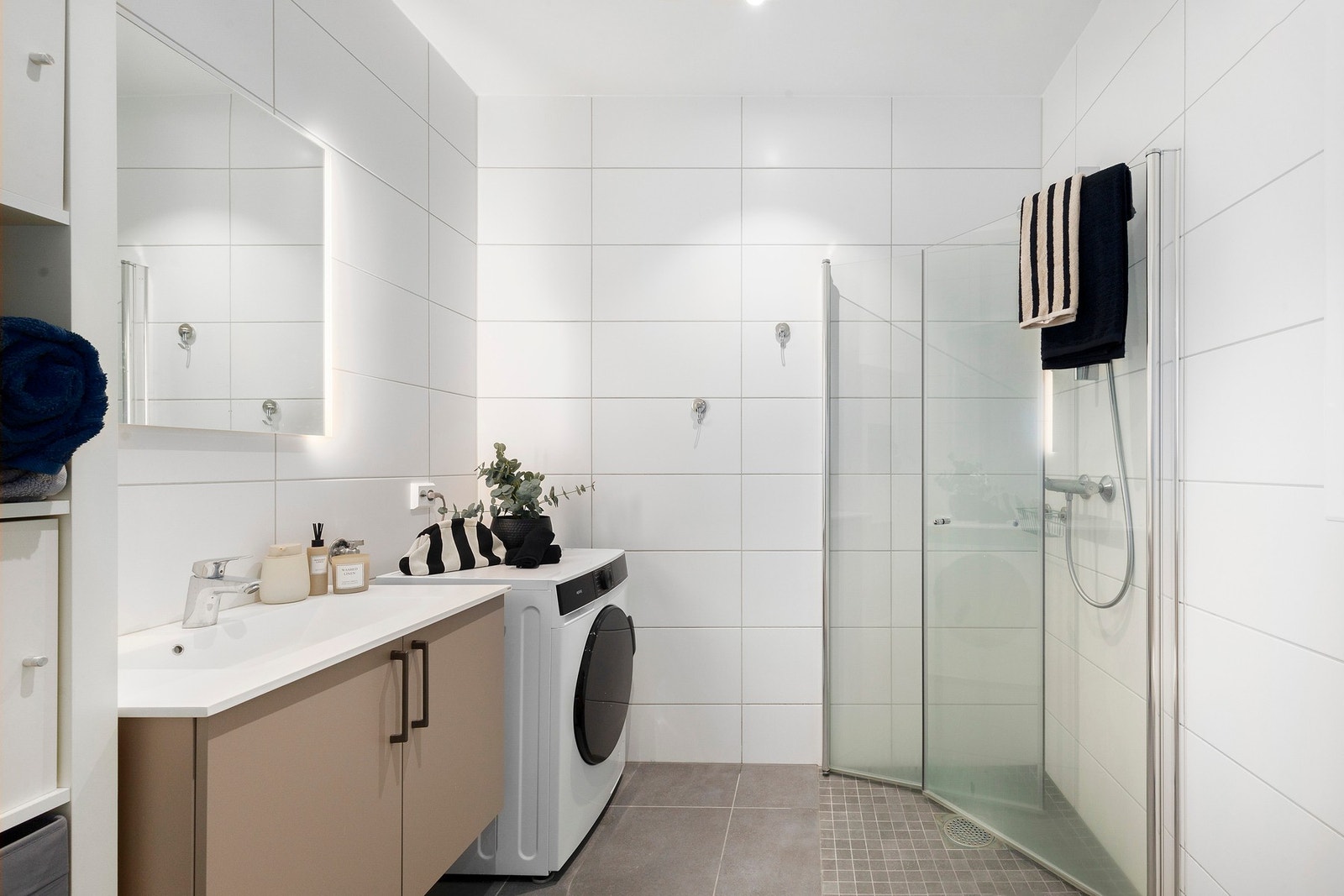 Flislagt baderom med gulvvarme og malte overflater med downlights i himling. Galleribilde