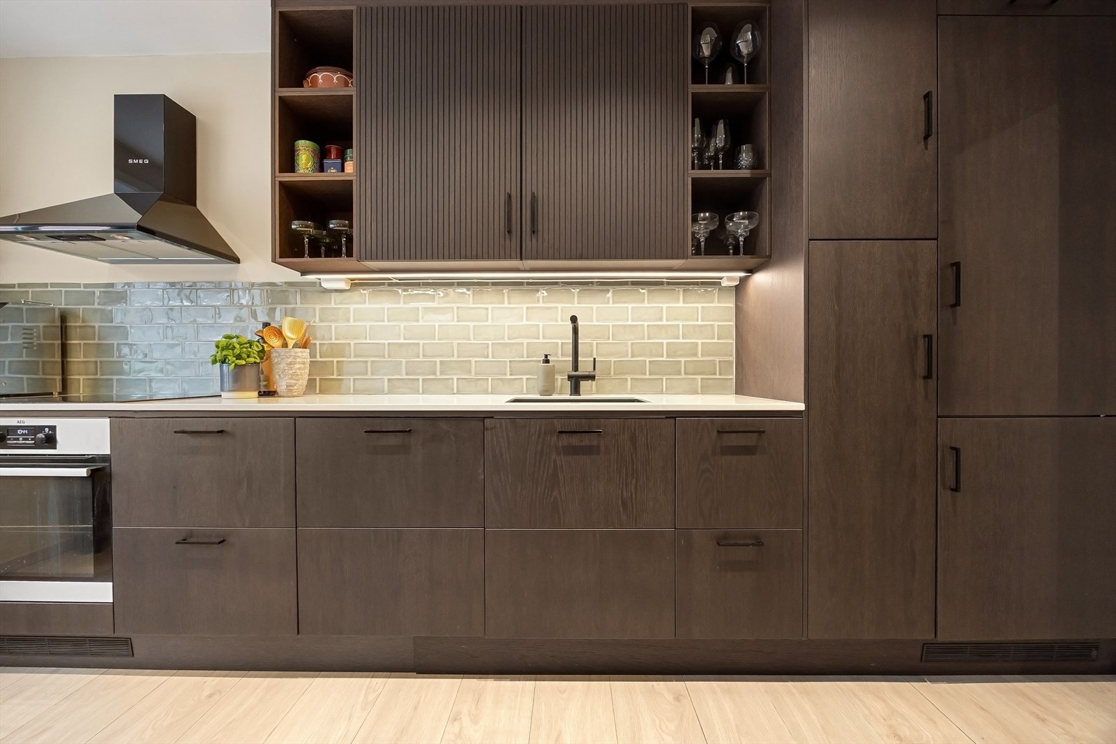 Moderne kjøkken fra 2024 med glatte fronter, komposittbenkeplate og integrerte hvitevarer - kjøl/frys, oppvaskmaskin, induksjonstopp og stekeovn Galleribilde