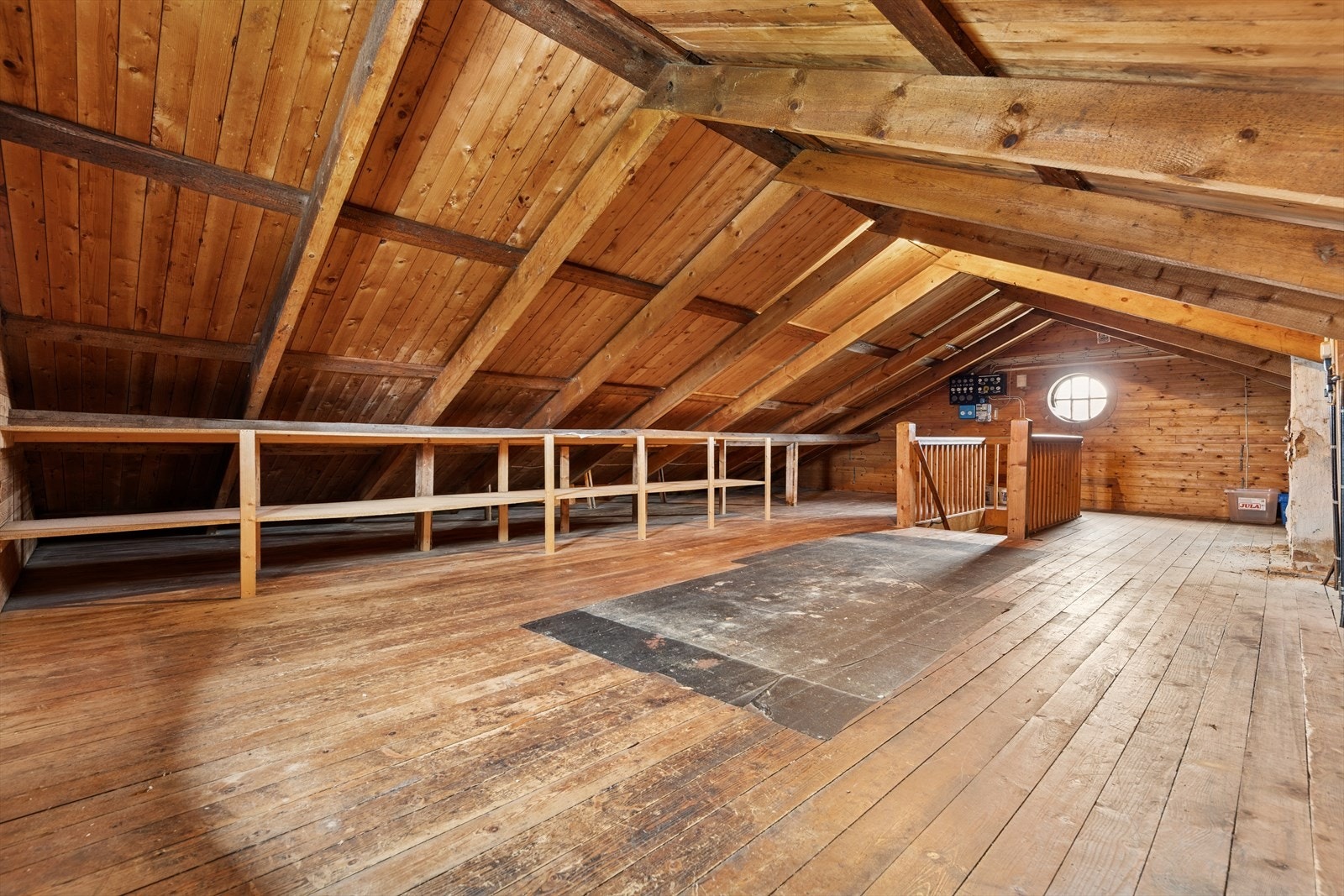 Romslig og luftig loft med synlige bjelker og originale tregulv - et areal med mange muligheter for den som ønsker ekstra plass. Galleribilde