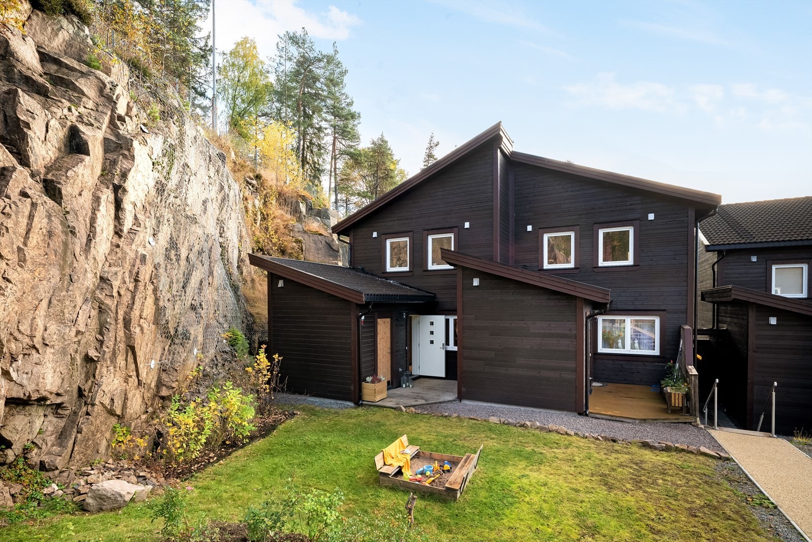 Uteområder på tre sider av huset, med både plen og markterrasse. Galleribilde