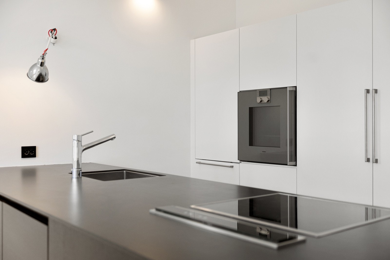 Integrerte hvitevarer og praktisk kjøkkenøy som gir gode arbeidsflater og oppbevaringsmuligheter. Galleribilde