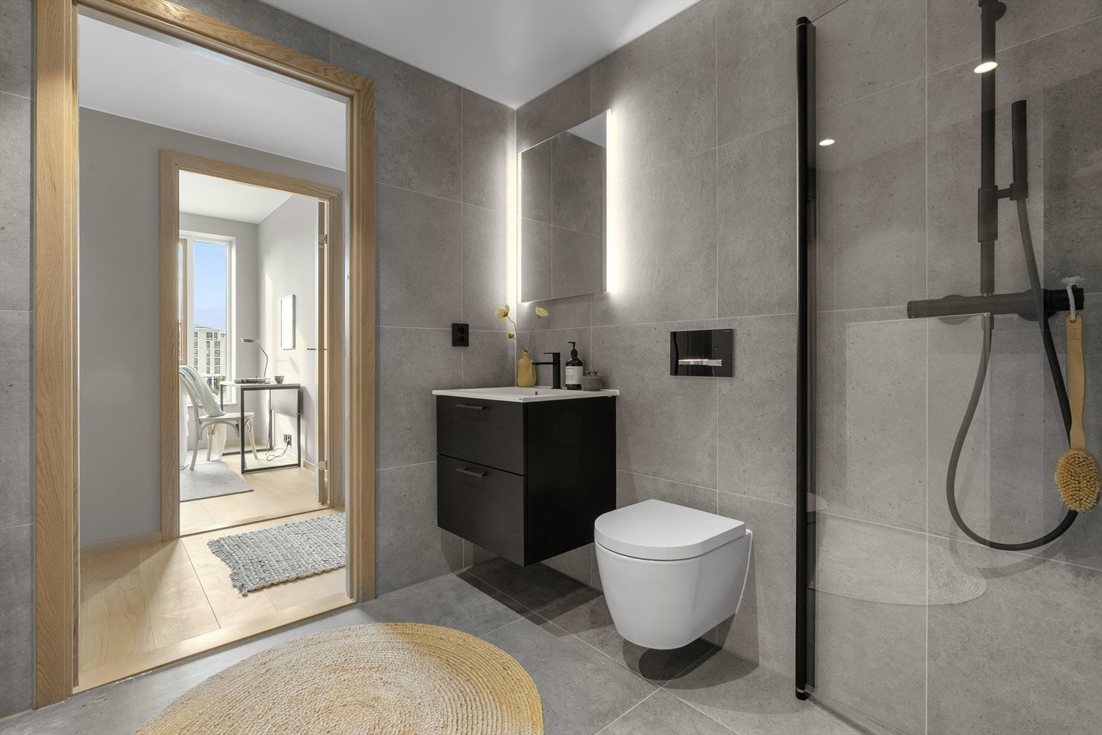 Flislagt bad med heldekkende servant på underskap, speil med belysning, vegghengt toalett og dusj med glassvegger. Opplegg til vaskemaskin og tørketrommel. Galleribilde