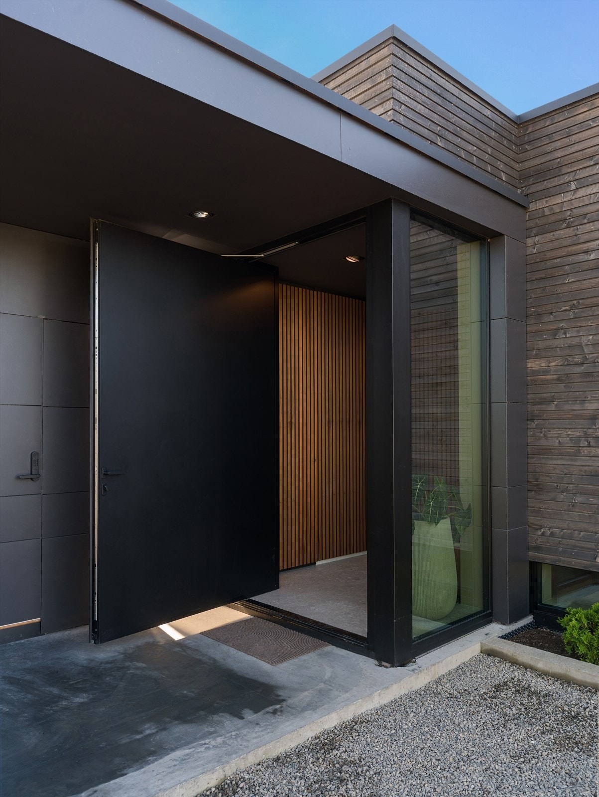 Pivot-hengslet dør i imponerende format ønsker deg velkommen til en bolig i særklasse. Galleribilde