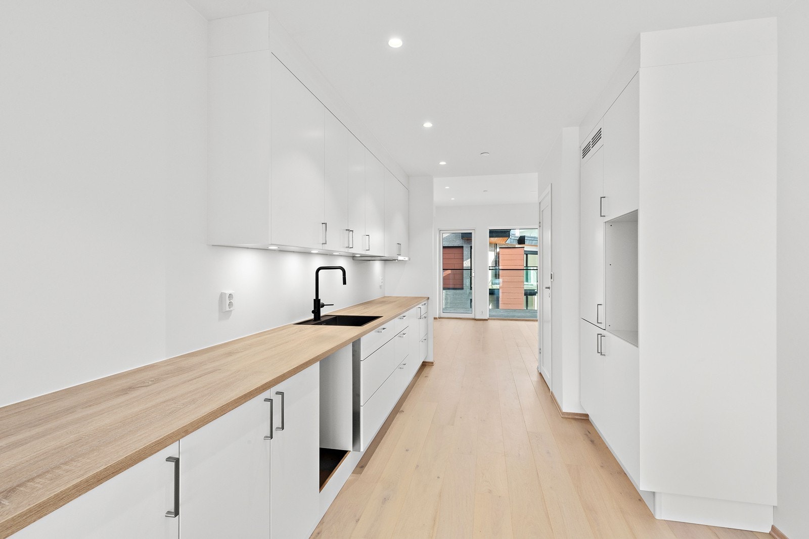 Lekkert kjøkken med takhøye overskap og god benkeplass. Galleribilde