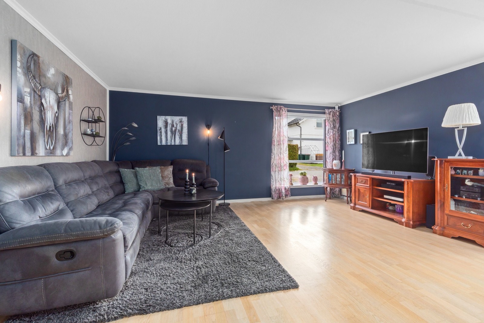 Stuen er malt i moderne og dempede farger. Dette er en flott arena for hyggelige sammenkomster. Galleribilde