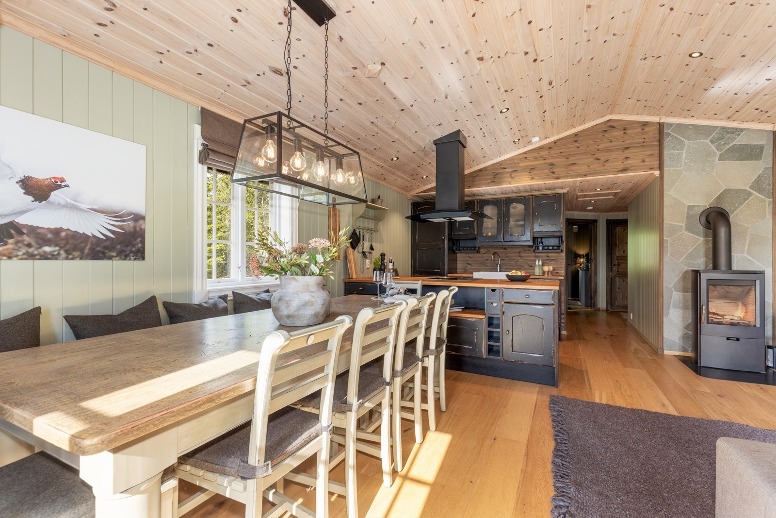 I den ene delen er det en koselig sofakrok, mens det ved kjøkkenet er mulighet for langbord med god plass til hyggelige familiemåltider og lystige vennelag. Galleribilde