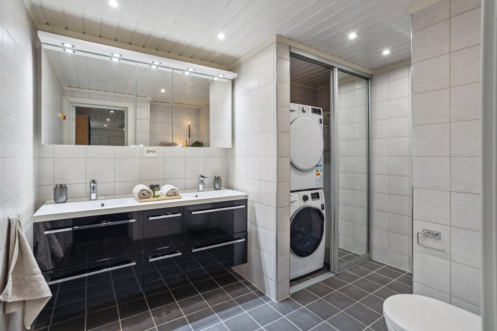 Herlig bad fra 2014 i sokkeletasje med dusjnisje og nisje for vaskemaskin og tørketrommel. Praktisk og stilreint Galleribilde