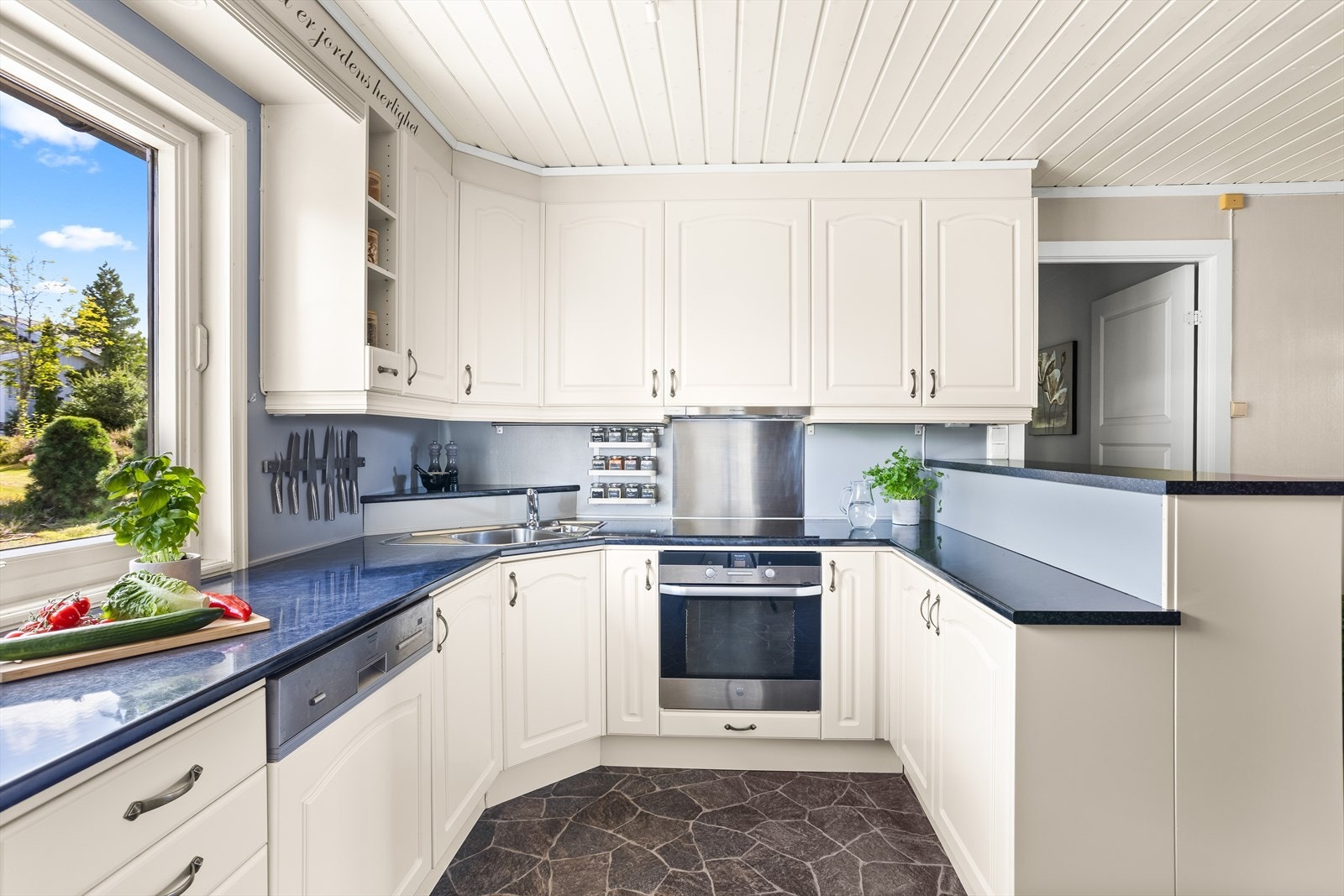 Innredningen består av profilerte fronter, benkeplater med laminerte overflater og oppvaskkum. Galleribilde