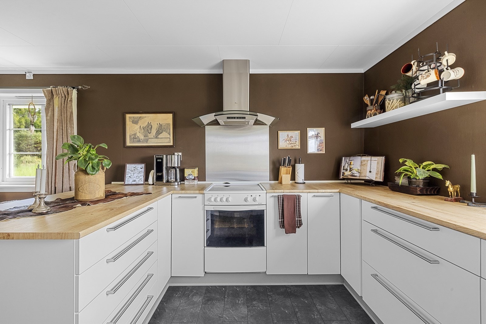 Innredningen er delikat med glatte fronter, laminat benkeplate og smarte oppbevaringsløsninger Galleribilde