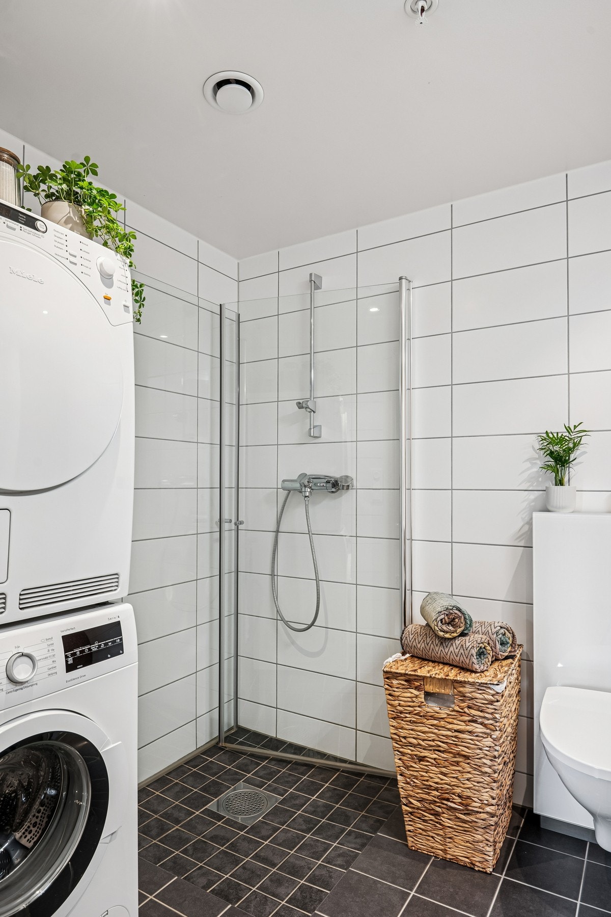 Det er opplegg for både tørketrommel og vaskemaskin og rommet har elektriske varmekabler for behagelig gulvvarme. 1 flis med misfarging/skade
mot dusj. Galleribilde