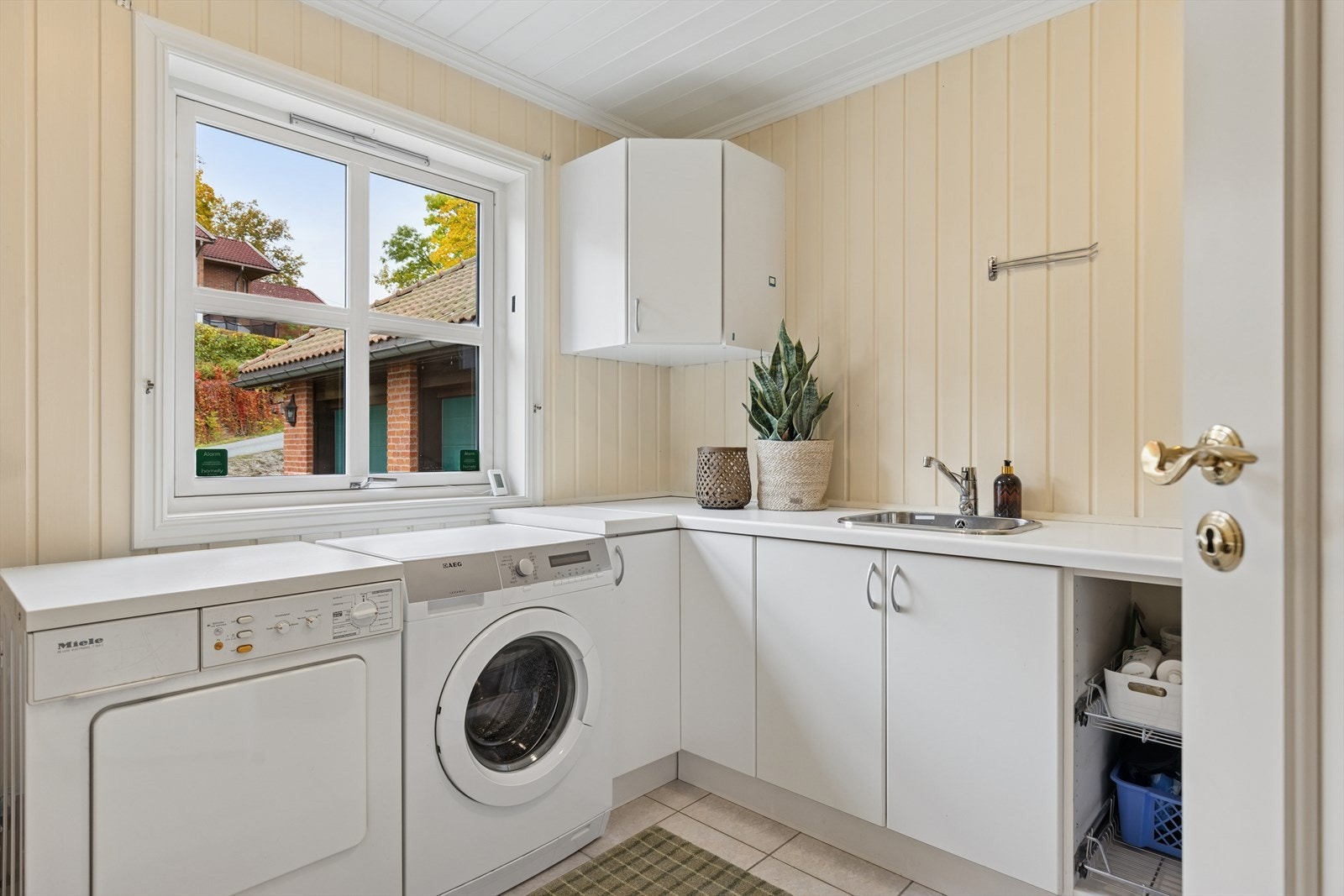 Eget vaskerom med god plass til vaskemaskin, tørketrommel og praktisk arbeidsbenk Galleribilde