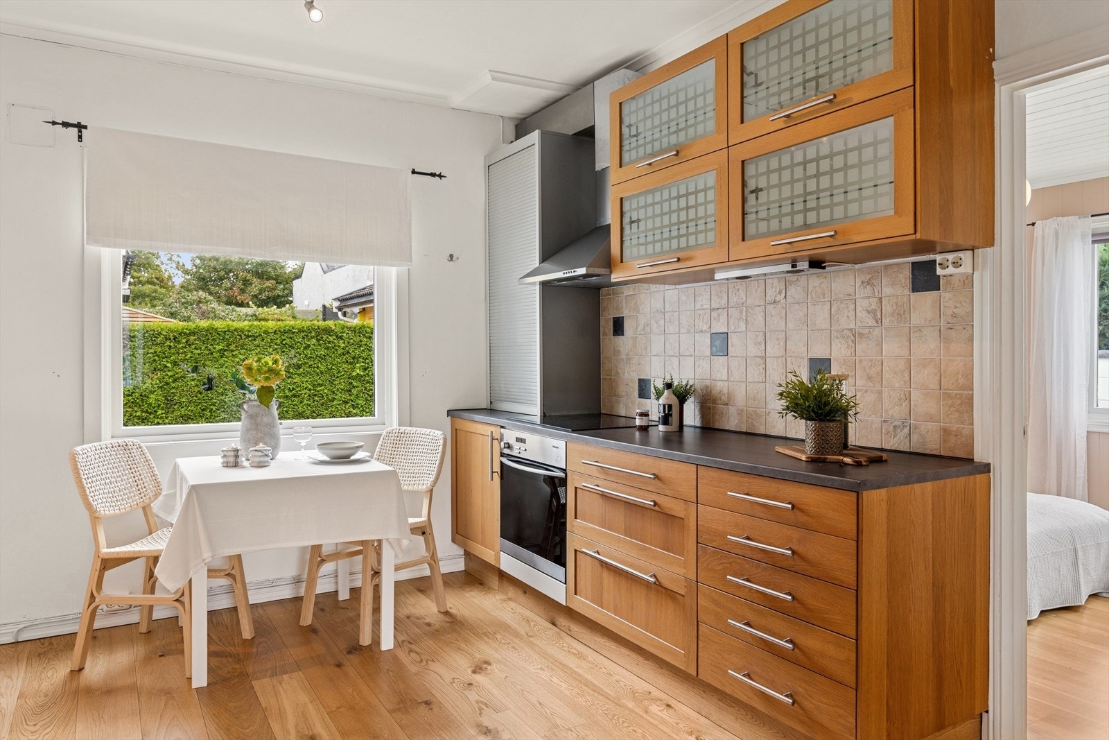 Veggen mellom benkeplate og overskap er flislagt. Galleribilde