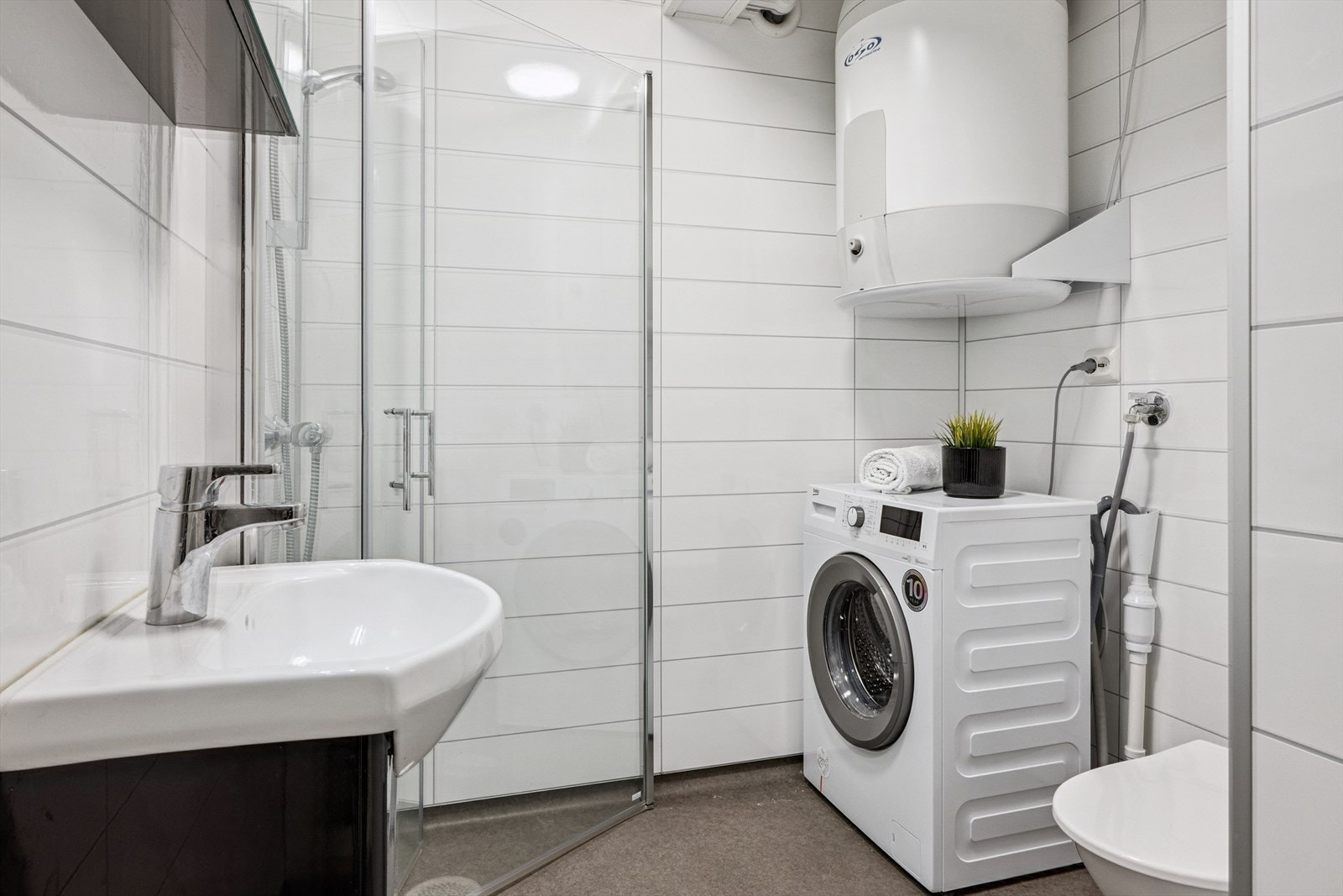 Lyst og pent bad med belegg på gulv, baderomsplater på vegger og malte plater i tak. Galleribilde