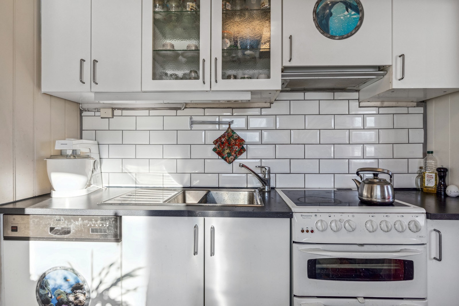 Kjøkkeninnredning med slette fronter, laminert benkeplate og vask i rustfritt stål Galleribilde