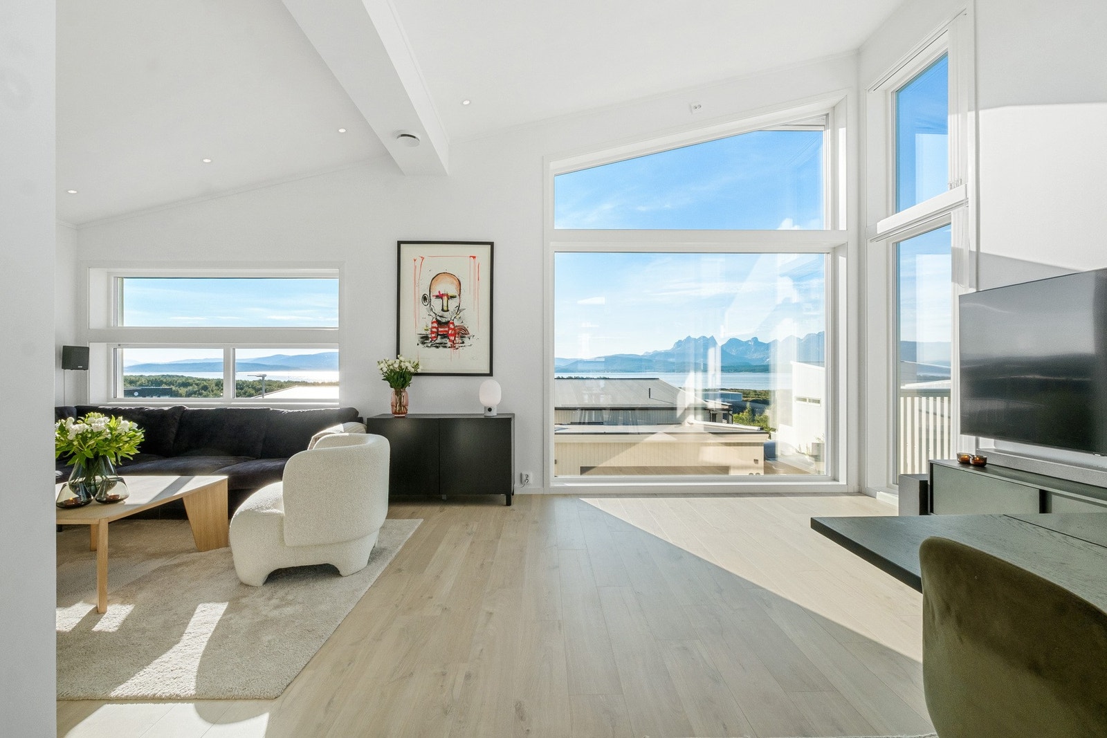 Store vindusflater slipper inn rikelig med naturlig lys og forsterker den luftige og åpne romfølelsen Galleribilde